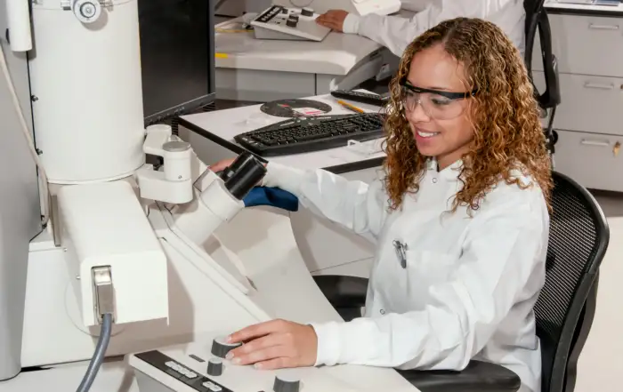 Lab technician operating an SEM and LIMS solution